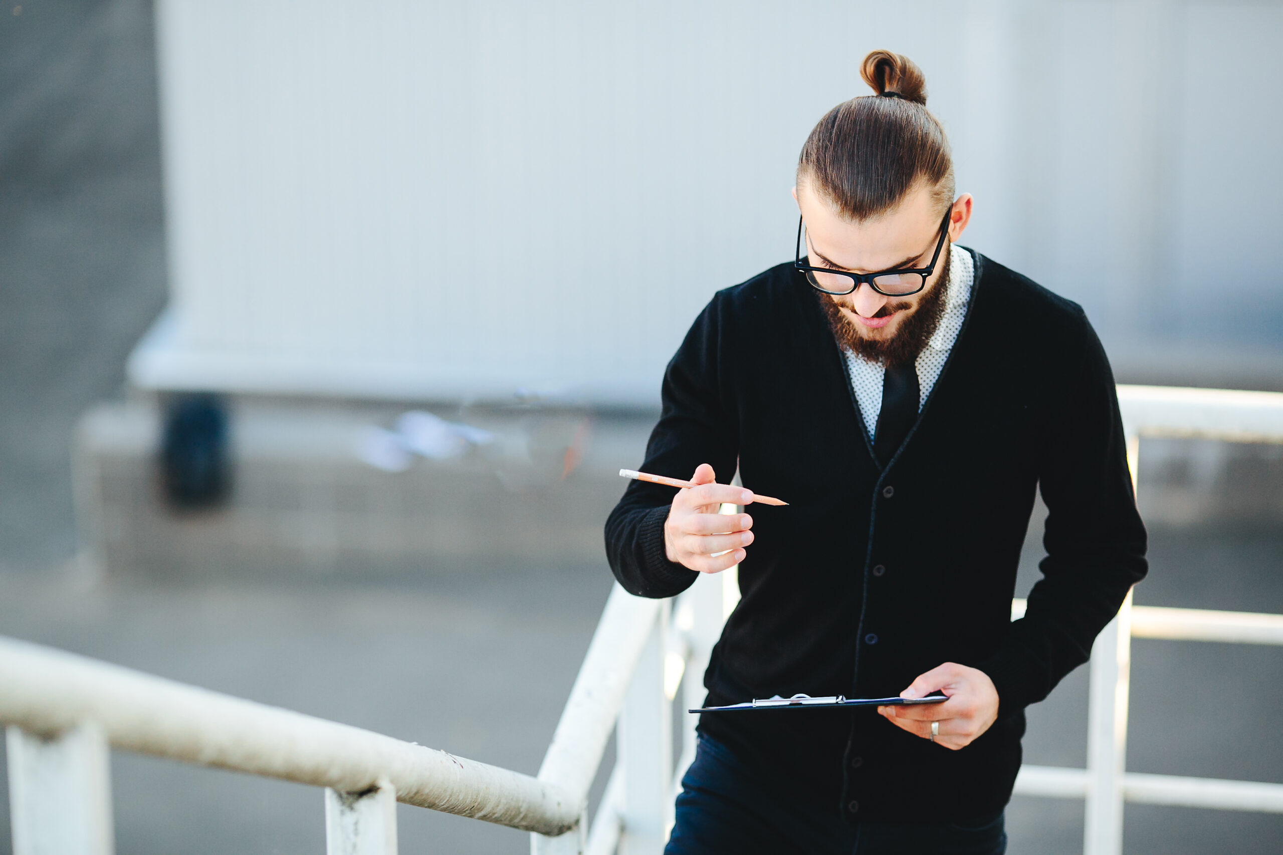 businessman stands with documents in hand